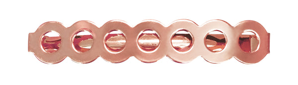 Image of a barrette that has a row of circles  in rose gold on a white background