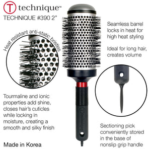 Hair styling brush with round bristle head and black handle on a white background