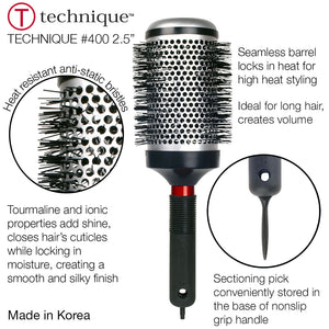 Hair styling brush with round bristle head and black handle on a white background