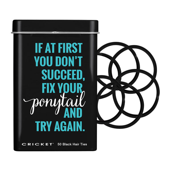 A black metal tin of Cricket brand hair ties with a motivational quote printed on the front, next to a stack of black elastic hair ties on a white background.