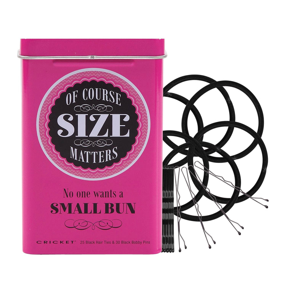 A bright pink rectangular metal tin with a hinged lid, featuring the text 'OF COURSE SIZE MATTERS' in a circular black-and-white label and 'No one wants a SMALL BUN' below it. Small text at the bottom reads 'CRICKET 25 Black Hair Ties & 30 Black Bobby Pins'.
