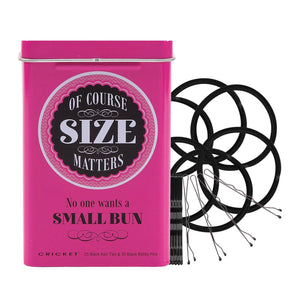 A bright pink metal tin with the text 'OF COURSE SIZE MATTERS No one wants a SMALL BUN' next to several black rubber buns and a pack of black bobby pins on a white background.