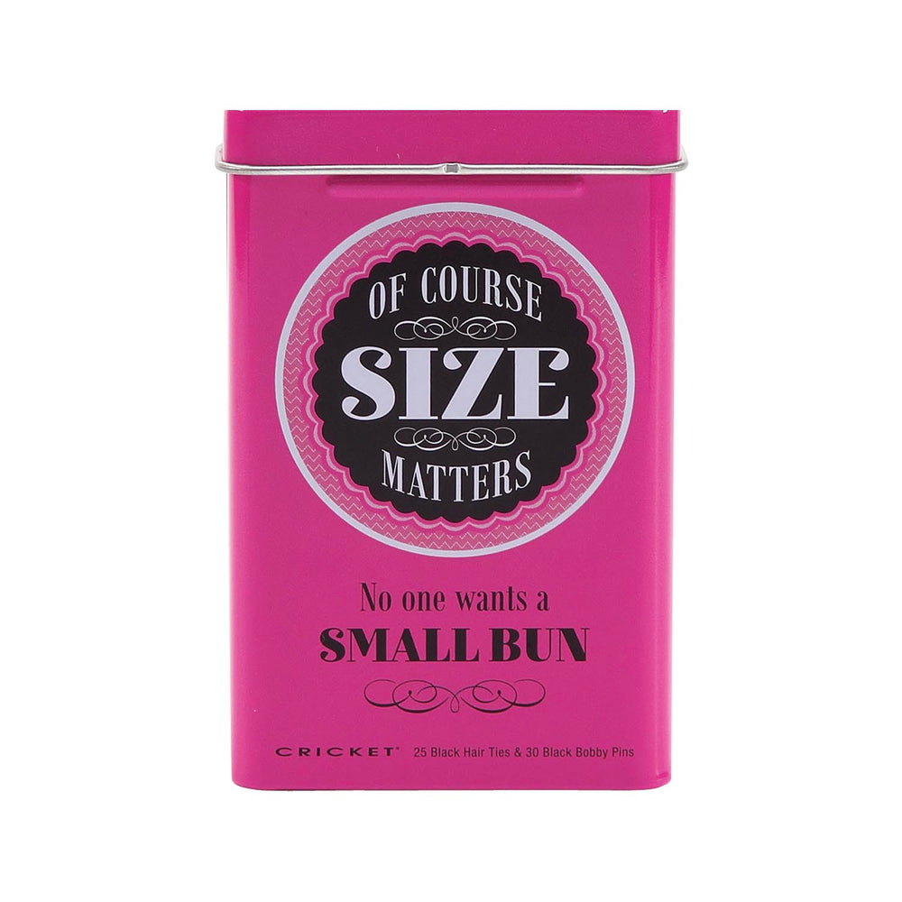 A bright pink rectangular metal tin with a hinged lid, featuring the text 'OF COURSE SIZE MATTERS' in a circular black-and-white label and 'No one wants a SMALL BUN' below it. Small text at the bottom reads 'CRICKET 25 Black Hair Ties & 30 Black Bobby Pins'.