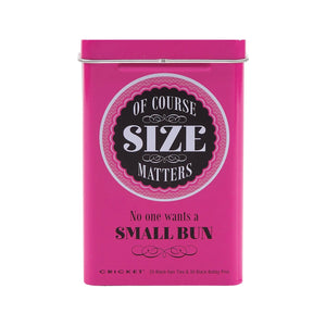 A bright pink rectangular metal tin with a hinged lid, featuring the text 'OF COURSE SIZE MATTERS' in a circular black-and-white label and 'No one wants a SMALL BUN' below it. Small text at the bottom reads 'CRICKET 25 Black Hair Ties & 30 Black Bobby Pins'.