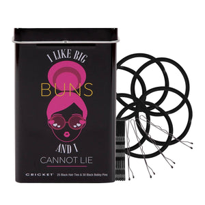 A black metal tin with a pink and yellow graphic of a woman with large buns, next to several black hair ties and bobby pins on a white background. The tin reads 'I LIKE BIG BUNS AND I CANNOT LIE' and 'CRICKET'.