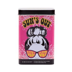 A rectangular metal tin of CRICKET brand 'Sun's Out' classic black hair tips on a white background. The tin features a vibrant pink cover with a retro illustration of a woman with a high bun wearing pink sunglasses, and bold yellow text.