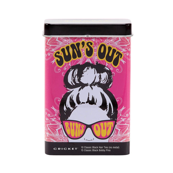 A rectangular metal tin of CRICKET brand 'Sun's Out' classic black hair tips on a white background. The tin features a vibrant pink cover with a retro illustration of a woman with a high bun wearing pink sunglasses, and bold yellow text.