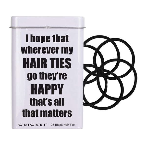 A white metal tin with a humorous quote about hair ties, shown next to several black elastic hair ties on a plain white background.
