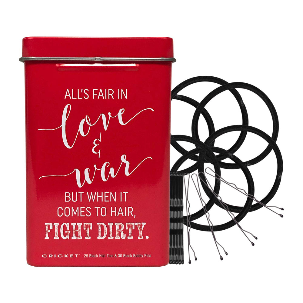 A red rectangular metal tin with a lid, featuring white printed text that reads, 'ALL'S FAIR IN love & war BUT WHEN IT COMES TO HAIR, FIGHT DIRTY.' Small text at the bottom reads 'CRICKET' and '25 Black Hair Ties & 30 Black Bobby Pins.