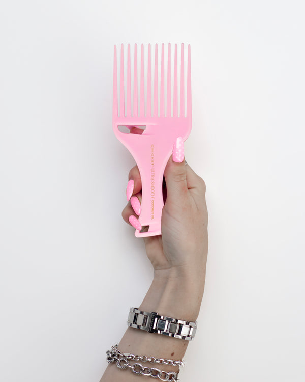 Ultra Smooth Coconut Pick Comb in Pink in a hand